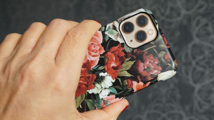 Apple iPhone with a floral case on it.